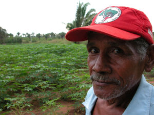 Member of the MST standing in a field, Brazil.