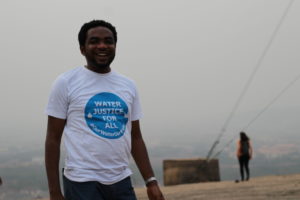Nigerian activist wearing Water Justice for All t-shirt.