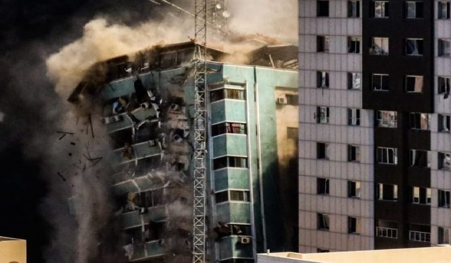 Building falls after being hit by an Israeli missile