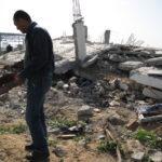 A man in Gaza surveys a destroyed building, 2010.